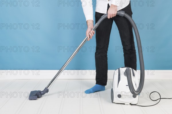 Man with vacuum cleaner cleaning the interior