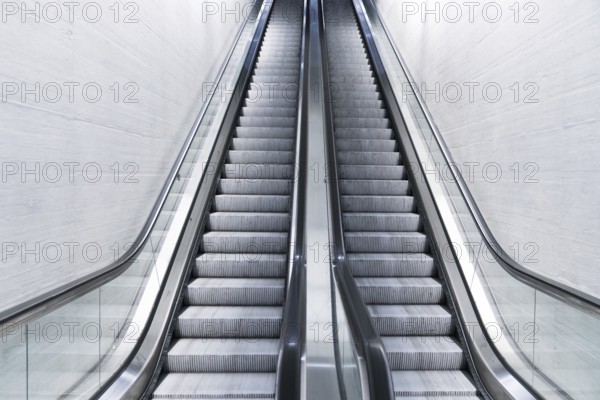 A horizontal view of an empty long escalator in a train station