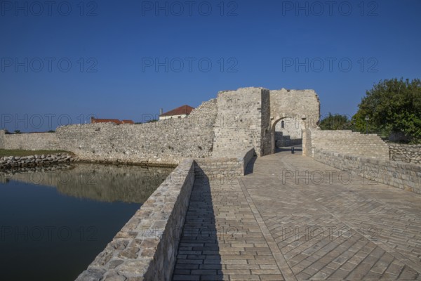 Skyline of a small Mediterranean town, historic city centre with massive city walls on an island in
