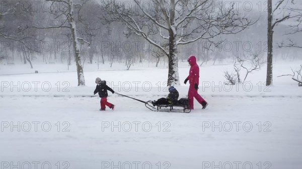 CHISINAU, MOLDOVA - JANUARY 29, 2021 Beautiful scene in the winter park with a mother and child