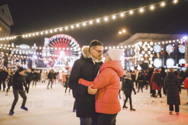 Couple hugging in Saint Valentine's Day. Young romantic couple having fun outdoors in winter. St