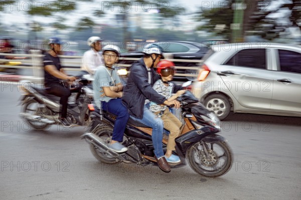 People riding motorbikes in city traffic, wearing helmets, blurred background, The crazy traffic of