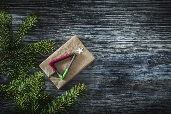 Pine tree branches gift box on wooden board