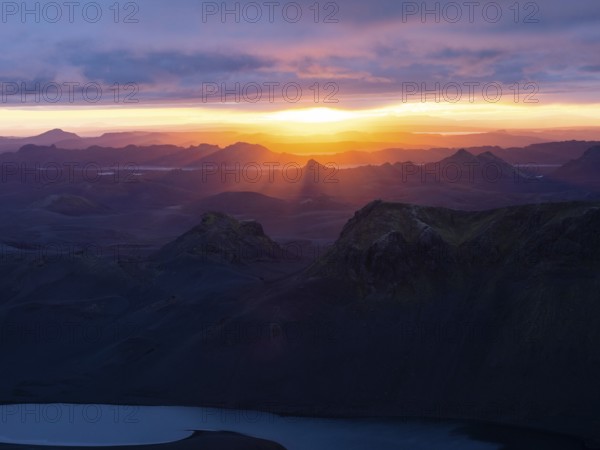 Cloudy mood and evening light at sunset, view from Mount Sveinstindur, volcanic landscape, Lake