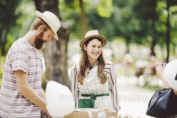 Theme is a family small business cooking sweets. A pair of lovers A young man and woman trader in