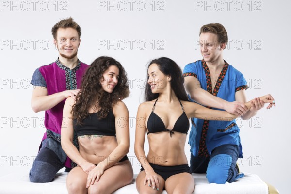 Theme massage and body care. Two brother Caucasian man in uniform make massage of hands and