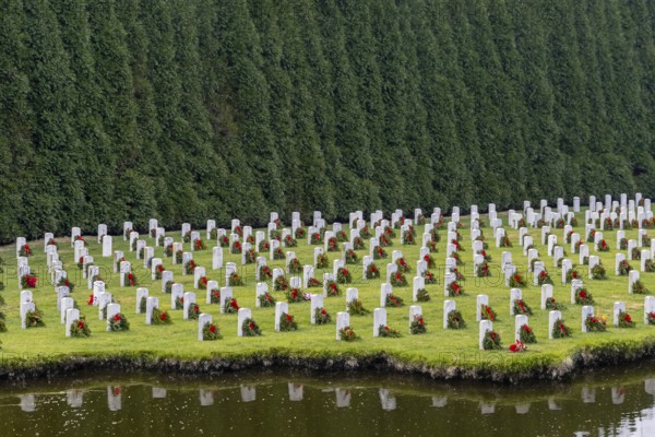 Atop a hill, a veterans cemetery with white headstones and the American flag evokes deep honour,