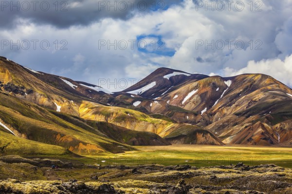 Valley National Park Landmannalaugar. On the gentle slopes of the mountains are snow fields and