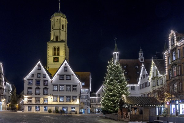 Night photo of historic buildings around the market square with Christmas tree and Christmas lights