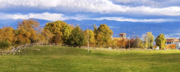 Bansko, Bulgaria autumn panorama banner background with colorful green, red and yellow trees, Rila