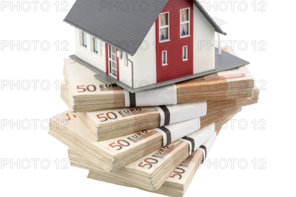 House on euro banknotes, symbolic photo for house purchase, financing, building society savings