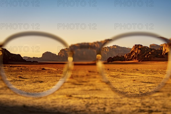 View at the Wadi Rum desert in Jordan through glasses during a nice sunset with clear sky. Travel,
