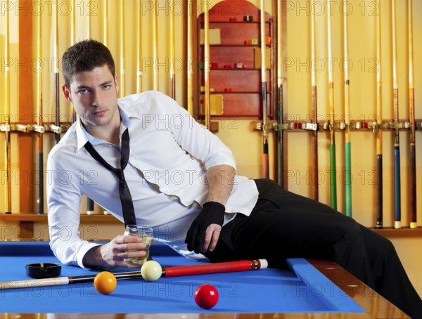 Billiard handsome player man drinking some alcohol in club