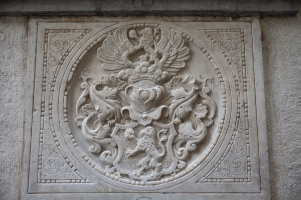 Coat of arms, stone relief on a gravestone, exterior facade of the cathedral, Graz, Styria,