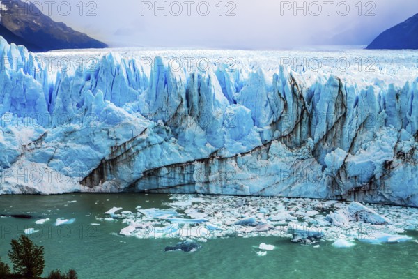 The colossal Glacier Perito Moreno in Patagonia on Lake Argentino. The cloudy sky covers the