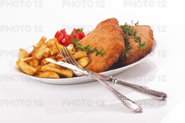 Pork schnitzel with chips on a porcelain plate