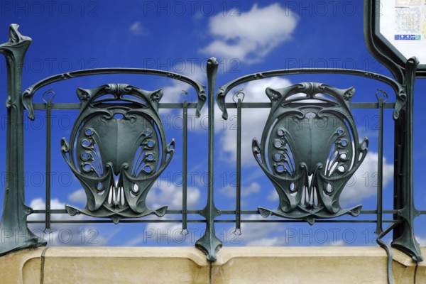 Railing of a Paris metro station with typical floral Art Nouveau elements. Landscape format.