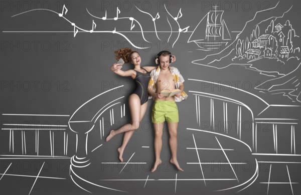 Love story concept of a romantic couple on the shore against chalk drawings background, view from