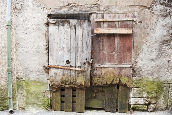 Very old wooden rotten doors in French building