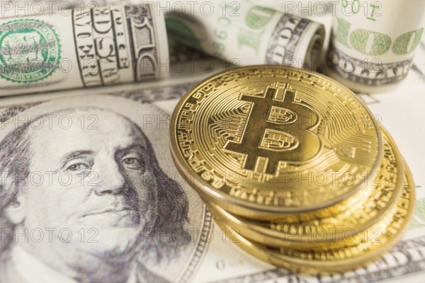 Bitcoin stack and banknotes of one hundred dollar. Conceptual image for global cryptocurrency