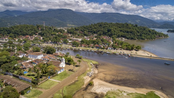 Aerial view to historic town Paraty, tidal river and Jabaquara with green mountains in background