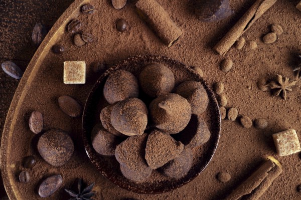 Healthy delicious chocolate truffles around ingridients with natural cocoa beans, powder, cacao