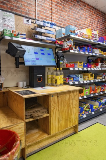 Digital checkout and shelves full of products in a modern supermarket, Tante M, self-service shop,