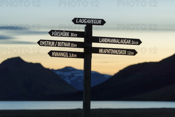 Signpost for hikers stands out against the evening sky, Laugavegur, Iceland's most famous hiking