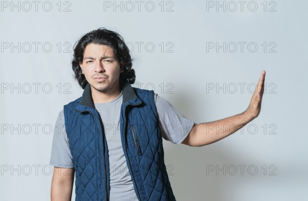 Displeased young man rejecting with palms hands isolated. Upset person making rejection gesture
