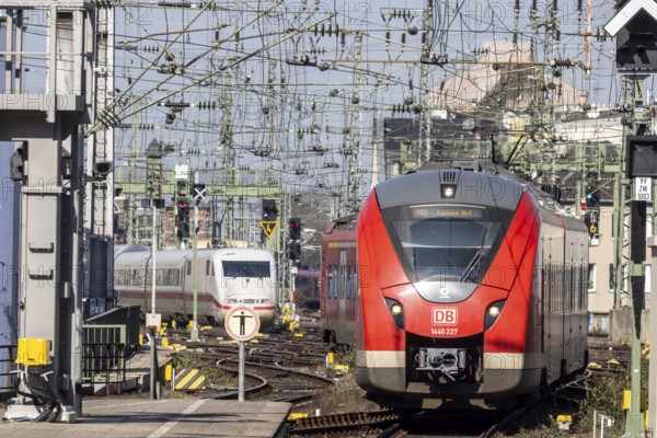 Central station with track apron, rails and overhead lines. ICE and regional train of Deutsche Bahn