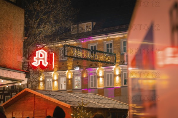 An illuminated pharmacy and the market street at night, Lichternacht Fest, Nagold, Black Forest,