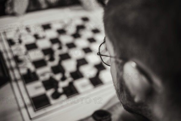 Chess player at the chessboard thinking about his next move, Leoben, Styria, Austria, Europe