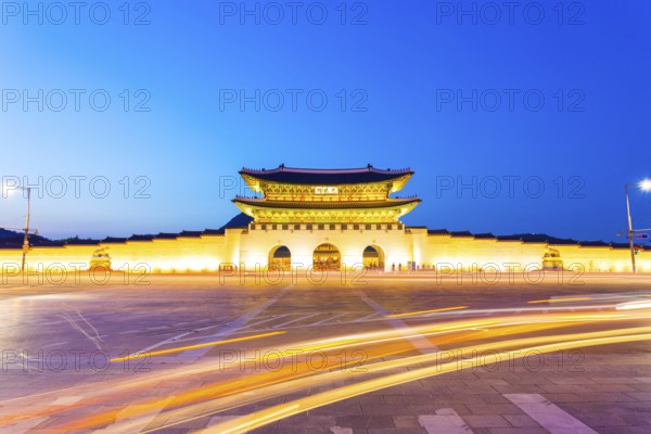 Long exposure car lights curving in front of Gwanghwamun main entrance gate to Gyeongbokgung Palace