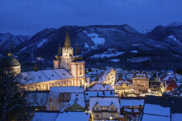 View of Mariazell illuminated for Christmas, basilica and main square, blue hour, Mariazell,