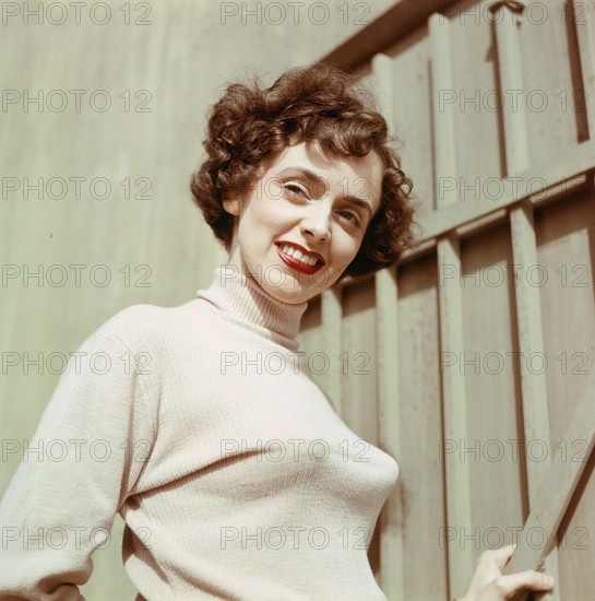 1950s jumper fashion. A swedish young woman wearing a typical 50s sweater. Under it she is wearing