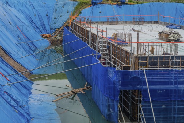 Daejeon, South Korea, August 9, 2020: Foundation for building under construction surrounded by high