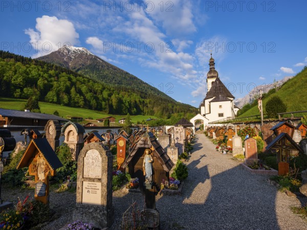 The old cemetery of the parish church of St Sebastian, Reiteralpe at the back, Ramsau,
