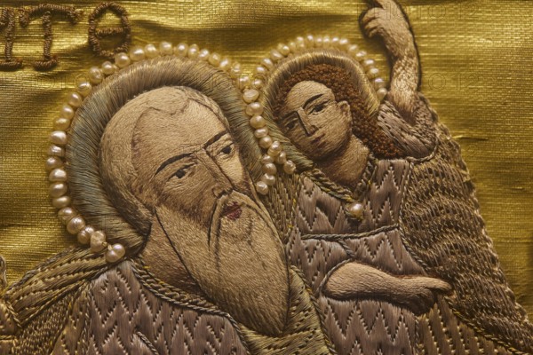 Detailed embroidery of a saint with pearl jewellery on golden fabric, Museum of Icon Painting,