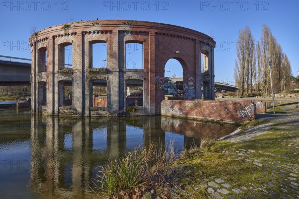 Park, pond, artificial ruin, trees, car and pedestrian bridge, symmetrical reflections, water