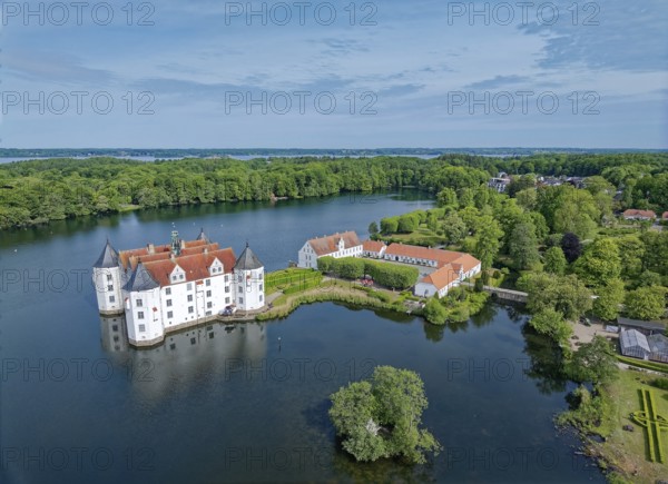 Glücksburg Castle and the castle pond. The lake is part of the Munkbrarupau stream. Aerial view.