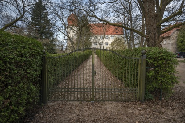 Moated castle with entrance gate, originally a manor house, converted into a Renaissance castle