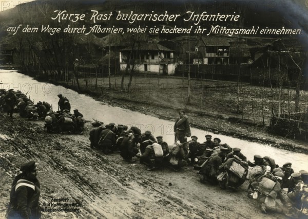 Short rest of Bulgarian infantry on their way through Albania, having their lunch while crouching,
