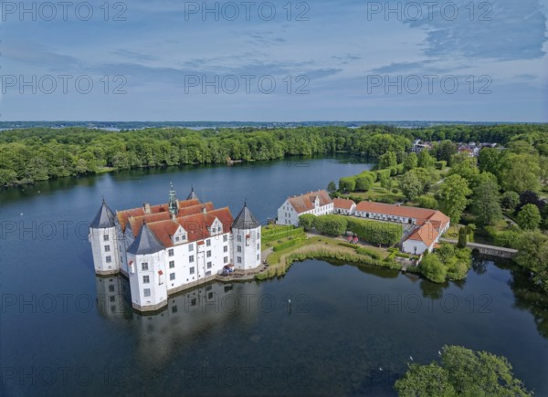 Glücksburg Castle and the castle pond. The lake is part of the Munkbrarupau stream. Aerial view.