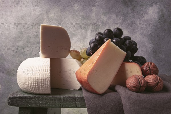 Georgian cheese, Imeretian and smoked suluguni, grapes, nuts, on a cutting board, Georgian cuisine,