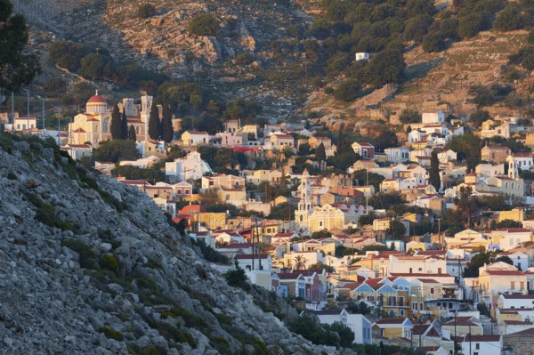 A picturesque hilltop village with traditional stone houses and a summery atmosphere, Symi Town,