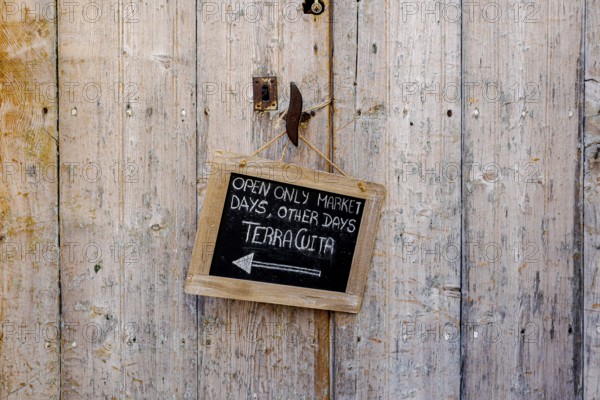 Wooden door with small slate plaque in the old town of Santanyi, Majorca, Balearic Islands, Spain,