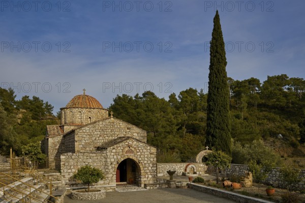 Stone church with cypress in front of a wooded background, Monastery Thari, Moni Thari, near