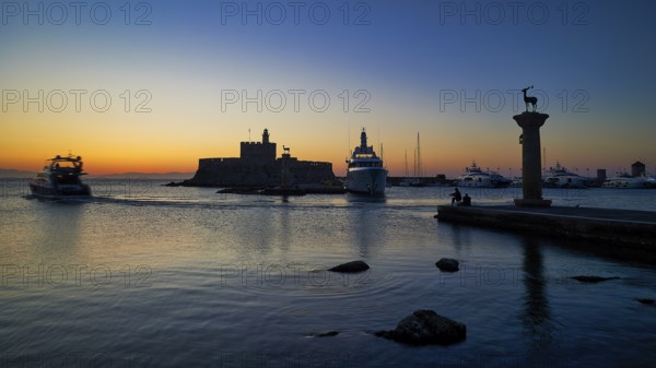 Harbour view at sunset with boats and a fortress, calm sea and evening atmosphere, sunrise, dawn,
