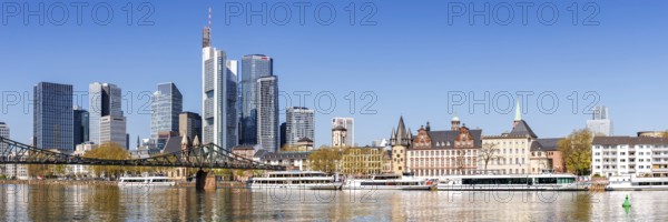 Frankfurt skyline skyscrapers with banks on the river Main panorama with excursion boats and