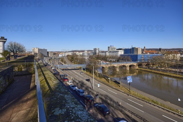 Long shot, castle fortification, river Saar, streets, cars, pedestrian bridge, trees, parking strip